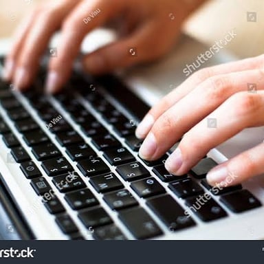 Hands entering text on a computer keyboard.