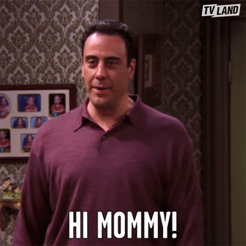 A person waving toward a camera while greeting their mother.